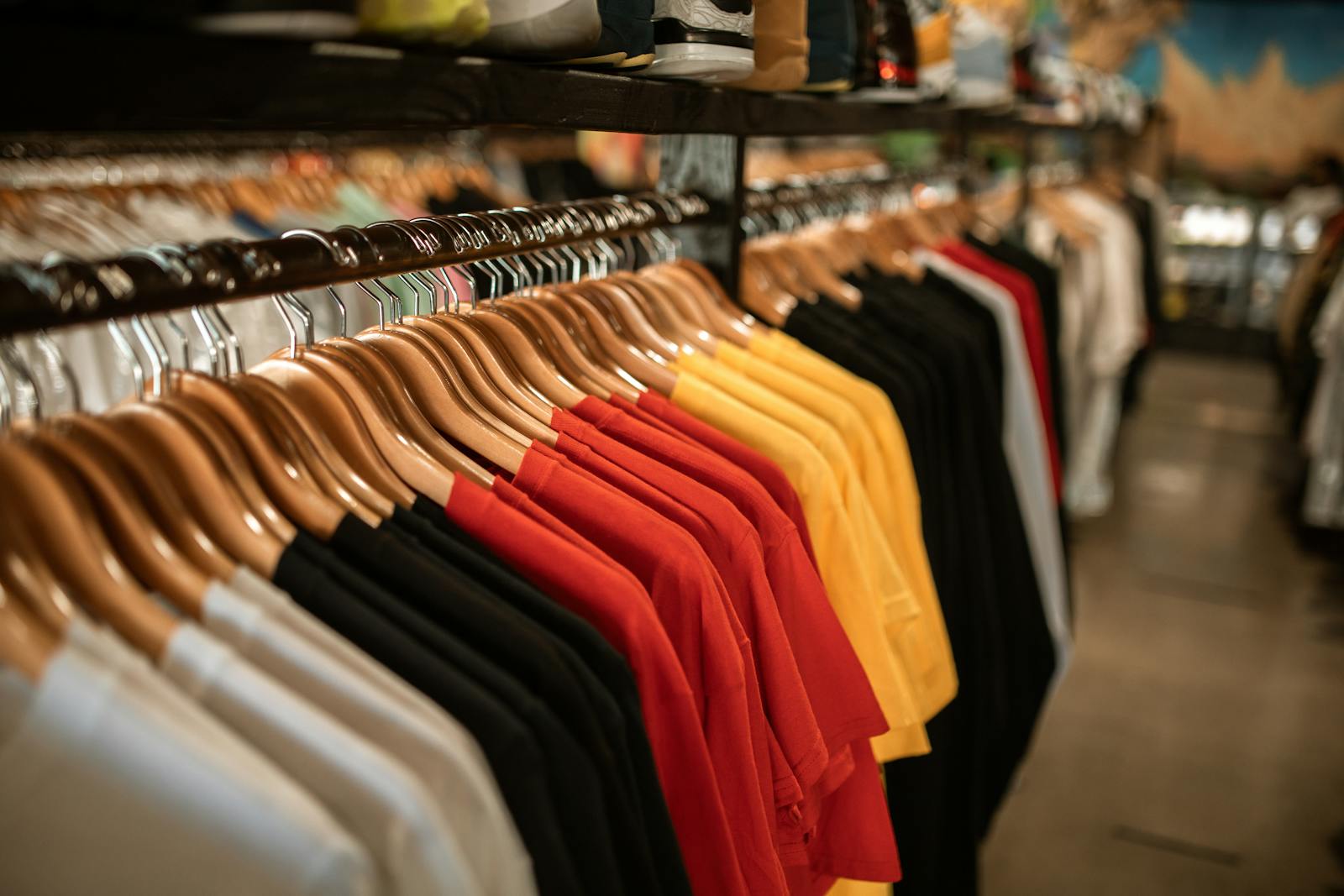 Clothing store display with shirts hanging neatly on a retail rack
