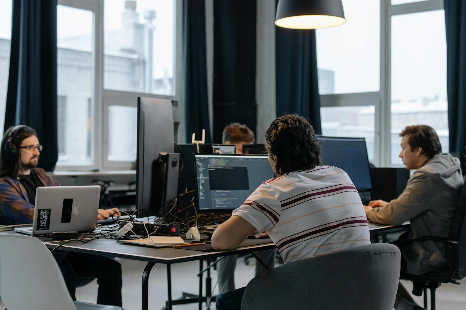 Team of developers working together on computers in a modern tech office